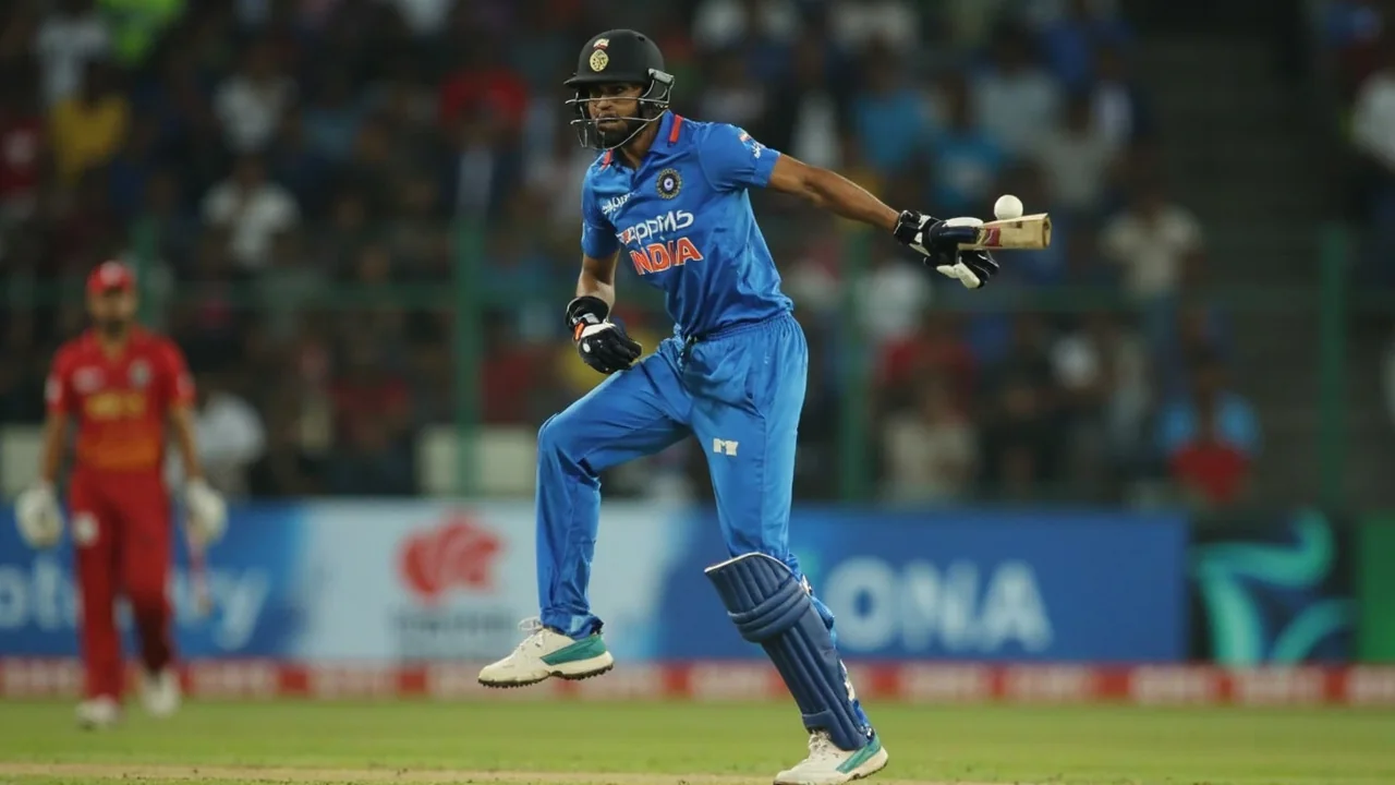 A right-handed batter plays a forceful shot through the off side during a T20 international under lights